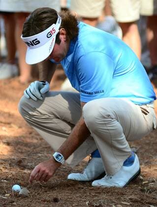 Bubba Watson (USA) moves debris away from his golf ball after hitting his tee shot on the 16th hole into the woods to the left of the 16th fairway during the first round of The Players Championship Thursday May 12, 2011 on the Stadium Course at TPC Sawgrass in Ponte Vedra Beach, Florida. ---  JAX2011051225
