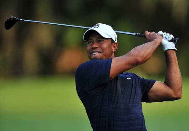 Tiger Woods grimaces as he hits his second shot from the fairway on 2nd hole during the first round of The Players Championship on May 12, 2011 on the Stadium Course at TPC Sawgrass in Ponte Vedra Beach, Florida. Woods later withdrew from the tournament citing a left knee and left achilles injury he said he suffered httiing his drive off the first tee. UPI Photo Rick Wilson  JAX2011051204