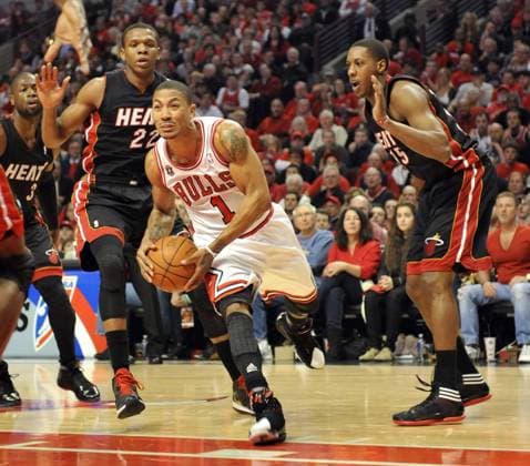Chicago Bulls guard Derrick Rose (C) is guarded Miami Heat forward James Jones (L) and Miami Heat guard Mario Chalmers during the firstquarter of game 1 of the Eastern Conference Finals at the United Center in Chicago on May 15, 2011.  DBX2011051503