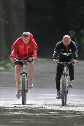 1.FC Köln Lukas Podolski hält sich fit für die Nationalmannschaft Runde mit dem Fahrrad um den Decksteiner Weiher Lukas Podolski mit Willi Breuer