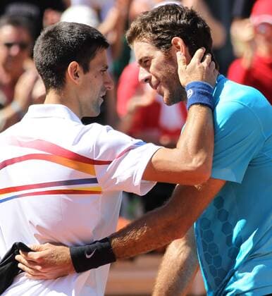 Novak Djokovic of Serbia (L) meets Juan Martin del Potro of Argentina at the net after their French Open mens third round match at Roland Garros in Paris on May 28, 2011. Djokovic defeated del Potro 6-3, 3-6, 6-3, 6-2 to advance to the fourth round.  PAR20110528762