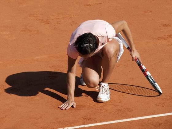 June 2, 2011 Francesca Schiavone of Italy, touches the red clay on the court after celebrating in the semifinal of the French Open, played at Stade Roland Garros, Paris France Tennis: JUN 02 French Open Icon250060211021 EDITORIAL USE ONLY
