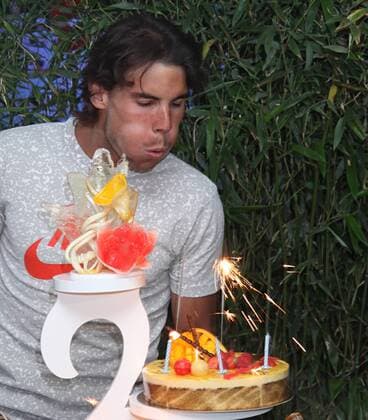 Rafael Nadal (ESP) attempts to blow out candles on a birthday cake on his 25th birthday after winning his French Open mens semifinal match at Roland Garros in Paris on June 3, 2011.  PAR20110603741