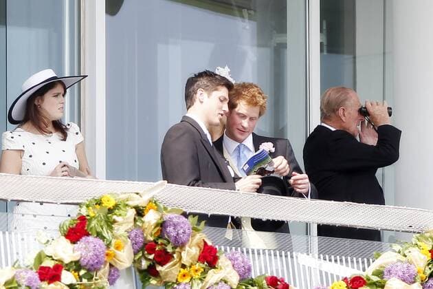 Horse Racing - The Derby Prince Harry checks the race card with a friend next to princess Eugenie of York at Epsom Racecourse 