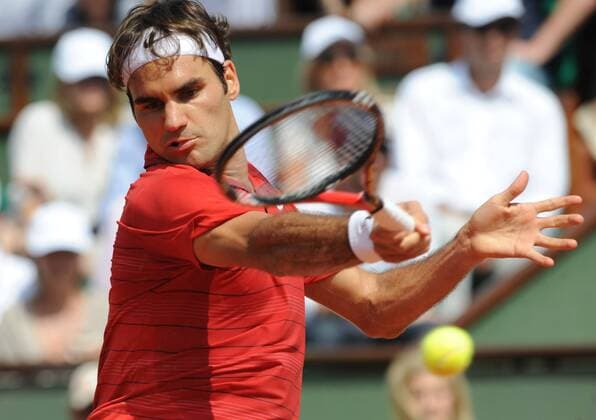 (110605) -- PARIS, June 5, 2011 -- Roger Federer of Switzerland returns the ball during their men s final in the French Open tennis championship at the Roland Garros stadium in Paris June 5, 2011. 