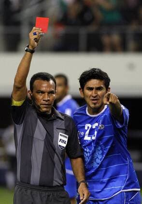 05 June 2011: Referee Enrico Wijngaarde issues a red card as El Salvador defender Luis Alonso Anaya (23) protests during the 5-0 Mexico victory over El Salvador in the first round of the CONCACAF Gold Cup game played at Cowboys Stadium in Arlington, TX SOCCER: JUN 05 CONCACAF Gold Cup - First Round - Mexico v El Salvador Icon1106050206 EDITORIAL USE ONLY