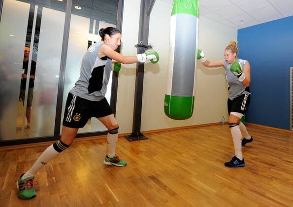 FRANKFURT AM MAIN, GERMANY - JUNE 13: Verena Faisst (L) and Kim Kulig (R) of German National Football Team are boxing during a Germany training session at Fitness First club on June 13, 2011 in Frankfurt am Main, Germany - 