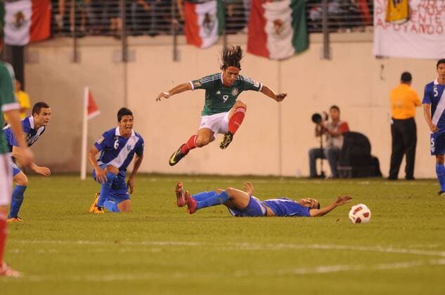 June 18, 2011 - East Rutherford, New Jersey, U.S - Mexico s Aldo de Nigris (9) leaps over Guatemala s Wilfred Velasquez (9) slide tackle during second half CONCACAF Gold Cup soccer quarterfinal action where Mexico defeated Guatemala 2-1 at the New Meadowlands Stadium in East Rutherford, N.J. CONCACAF Gold Cup Soccer - June 18 - Mexico vs Guatemala - ZUMAx50