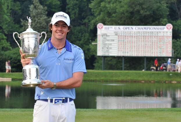 Northern Ireland s Rory McIlroy holds up the trophy after winning the U.S. Open Championship at Congressional Country Club in Bethesda, Maryland on June 19, 2011. McIlroy shot 2-under-par for 69 to finishing the tournament 16-under at 268, setting a new U.S. Open record.  WAP20110619328