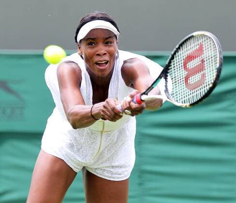 American Venus Williams returns the ball in her match on the opening day of the 125th Wimbledon Championships in Wimbledon,London on Monday June 20 2011.  LON2011062026