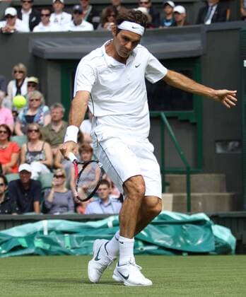 Swiss Roger Federer returns the ball in his match on the second day of the 125th Wimbledon Championships in Wimbledon,England on Tuesday, June 21, 2011.  LON2011062108