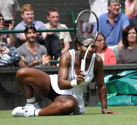 Serena Williams of the USA apologises for a shot in her match on the second day of the 125th Wimbledon Championships in Wimbledon,England on Tuesday, June 21, 2011.  LON2011062106