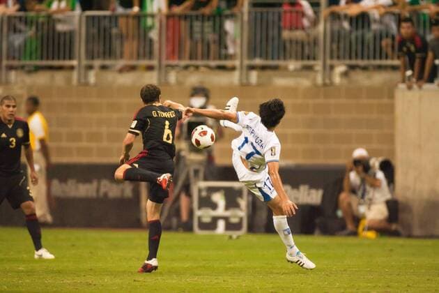 June 22, 2011 - Houston, Texas, U.S - Honduras Soccer player Roger Espinoza (17) and Mexico Soccer player Gerardo Torrado (6) push each other to get to the ball. player get s kick in the face by a Mexico player. Mexico defeated Honduras 2-0 in overtime. CONCACAF Gold Cup 2011 - Honduras vs Mexico - ZUMAq99