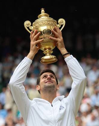 Serbia s Novak Djokovic holds the Wimbledon Men s Singles trophy after beating Spain s Rafael Nadal in the 125th Wimbledon Championships in Wimbledon,England on Sunday, July 03, 2011.  LON2011070312 o0 Pokal