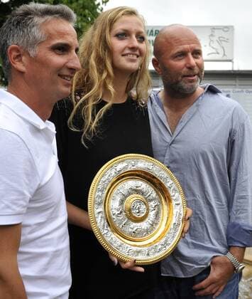 Czech tennis player Petra Kvitova, centre, who won ladies singles final at the All England Lawn Tennis Championships at Wimbledon, poses with the trophy after her presser in Prostejov on Monday, July 4, 2011. She is accompanied by her coach David Kotyza, right, and his assistent Jozef Ivanko, left. (CTKxPhoto VladislavxGalgonek)  CTKPhoto8201107040646801