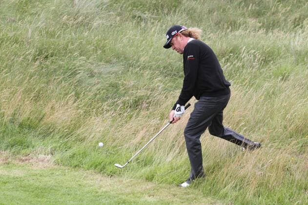 Spain s Miguel Angel Jimenez plays from the rough during practice day in the 140th Open Championship at Royal St Georges Golf club in Sandwich,England on Tuesday, July 12, 2011.  LON2011071210