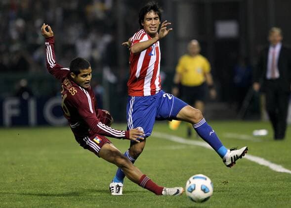 Paraguay s player Marcelo Estigarribia (R) fights for the ball with Roberto Rosales of Venezuela during the match for the group stage of Copa America 2011, in Salta 