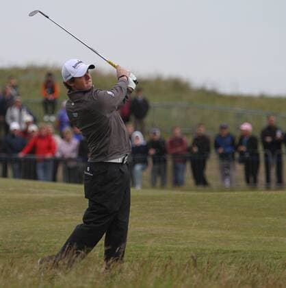 Northern Ireland s Rory McIlroy hits from the fairway on the 2nd hole on the first day of the 140th Open Championship at Royal St Georges Golf club in Sandwich, England on Thursday, July 14, 2011.  LON2011071404