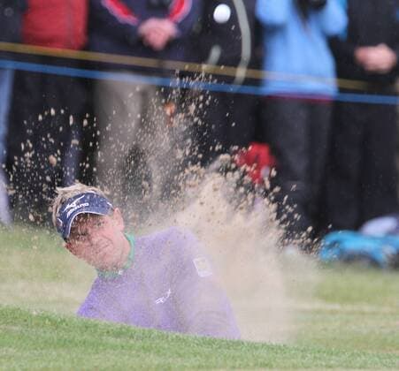England s Luke Donald hits out of the bunker on the first day of the 140th Open Championship at Royal St Georges Golf club in Sandwich, England on Thursday, July 14, 2011.  LON2011071406