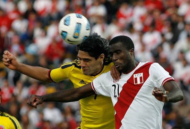 CORDOBA, July 16, 2011 -- Colombia s soccer player Radamel Falcao Garcia (BACK) vies for the ball with Christian Ramos (FRONT) of Peru, during the match of the quarter finals of Copa America 2011, Colombia vs Peru, in Cordoba city, on July 16, 2011. --- 