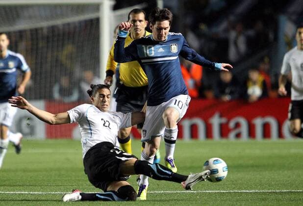 SANTA FE, July 16, 2011 -- The Argentina s soccer player Lionel Messi (C-Front) vies for the ball with Martin Caceres (Bottom) of Uruguay, during the match of quarterfinals of Copa America, Argentina vs Uruguay, in Santa Fe city, Argentina, on July 16, 2011. --- 
