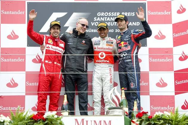 v.l. Fernando ALONSO (ESP), Ferrari, zweiter Platz, Simon ROBERTS (GBR, Renningenieur), Lewis HAMILTON (GBR), McLaren Mercedes, erster Platz, Mark WEBBER (AUS), Red Bull Racing, ganze Figur, Querformat, Siegerehrung, Jubel, jubeln, Freude, Rennen am 23.07.2011 Formel 1, Grosser Preis von Deutschland am Nürburgring vom 21.7. - 24.07. 2011, Saison2011,