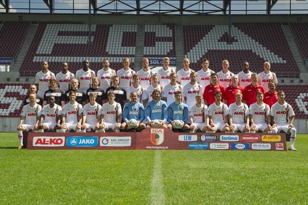 FC Augsburg, Saison 2011-2012, hinten v.li: Marcel NDJENG, Lorenzo DAVIDS, Gibril SANKOH, Sascha MOELDERS, Jonas DE ROECK, Uwe MOEHRLE, Jan-Ingwer CALLSEN-BRACKER, Dominik REINHARDT, Edmond KAPLLANI, Axel BELLINGHAUSEN, Nando RAFAEL, Michael THURK, mittlere Reihe v.li: Salvatore BELARDO (Zeugwart), Dr. Andreas WEIGEL, Dr. Peter STILLER (Mannschaftsärzte), James MORGAN, Markus ZEYER, (Physiotherapeuten), Sebastian LANGKAMP, Torsten OEHRL, Dominic PEITZ, Daniel BRINKMANN,Zdenko MILETIC (Torwarttrainer), Rob REEKERS, Markus GELLHAUS (Co-Trainer), Jos LUHUKAY (Trainer); vorne v.li: Tobias WERNER, Andrew SINKALA, Patrick MAYER, Moritz NEBEL, Paul VERHAEGH, Mohamed AMSIF (Torwart), Simon JENTZSCH (Torwart), Joannis GELIOS (Torwart), Stephan HAIN, Hajime HOSOGAI, Marcel De JONG, Daniel BAIER, Akaki GOGIA,