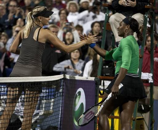Maria Sharapova (L) congratulates Serena Williams after match point at the Bank of the West Classic at Stanford University in California on July 29, 2011. Williams defeated Sharapova 6-1, 6-3.  SXP2011072913