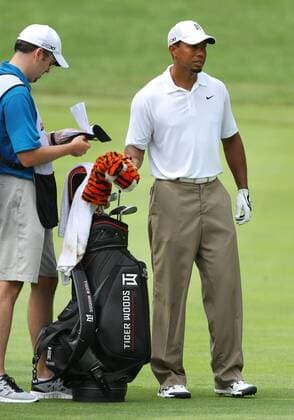 August 05 2011: Tiger Woods talking to his caddie Bryon Bell before his shot during the World Golf Championships-Bridgestone Invitational second round of play at Firestone Country Club in Akron, OH. PGA Golf Herren AUG 05 WGC Bridgestone Invitational - Second Round Icon1108051576 EDITORIAL USE ONLY