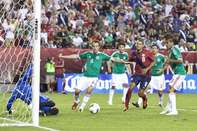August 10, 2011: Mexico defender Gerardo Torrado (6) trying to clear the ball after the save by goal keeper Guillermo Ochoa (1) with USA midfielder Jermaine Jones (8) looking on during the international friendly match between the USA and Mexico at Lincoln Financial Field in Philadelphia, Pennsylvania. USA and Mexico tied 1-1. - ZUMAcs7