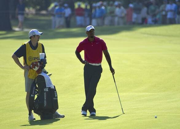 Tiger Woods (R) and his caddie Byron Bell wait on the 13th fairway during the first round of the 93rd PGA Golf Herren Championship at the Atlanta Athletic Club on August 11, 2011 in Johns Creek, Georgia.  BKX2011081109