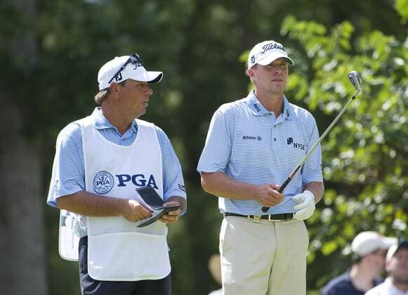 Steve Stricker (R) talks to his caddie Jimmy Johnson on the 17th tee during the first round of the 93rd PGA Golf Herren Championship at the Atlanta Athletic Club on August 11, 2011 in Johns Creek, Georgia.  BKX2011081125