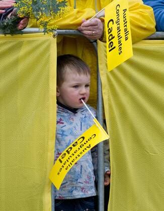 A boy holds a placard while waiting for the Tour de France winner Cadel Evans of Australia with some of the thousands of fans which lined the streets for his homecoming victory parade in Melbourne, Australia - 
