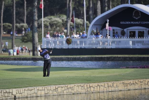 Tiger Woods hits a shot from the drop zone after hitting his approach shot in the water on the 18th hole during the second round of the 93rd PGA Golf Herren Championship at the Atlanta Athletic Club on August 12, 2011 in Johns Creek, Georgia.  BKX2011081260
