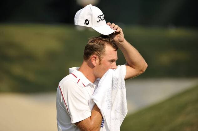 Brendan Steele wipes his face as he walks off the 15th green during the third round of the 93rd PGA Golf Herren Championship at the Atlanta Athletic Club on August 13, 2011 in Johns Creek, Georgia. After three rounds, Steele and Jason Dufner are tied for the lead of the tournament at 7 under par.  BKX2011081344