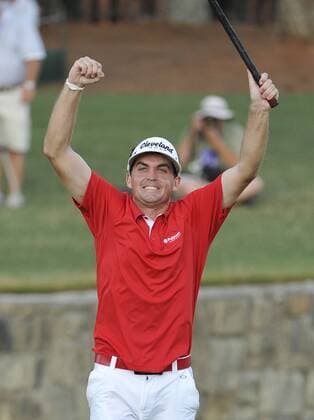 Keegan Bradley raises his arm after sinking a par putt on the 18th hole to win the 93rd PGA Golf Herren Championship at the Atlanta Athletic Club on August 14, 2011 in Johns Creek, Georgia. Bradley defeated Jason Dufner in a three-hole playoff to win the tournament by one stroke.  BKX2011081423