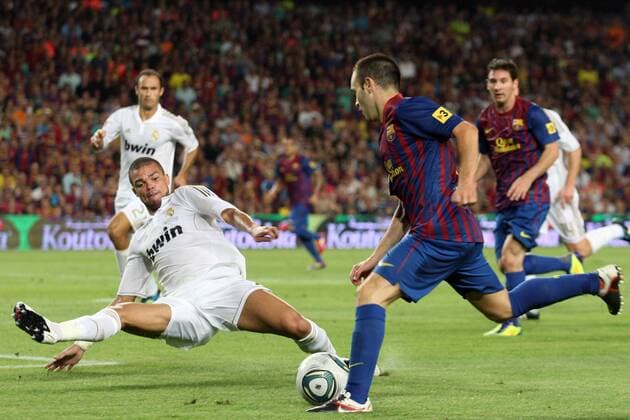 17.08.2011. Barcelona, Spain. Spanish SuperCup football competition, Barcelona FC versus Real Madrid at the Nou Camp stadium. Andres Iniesta of Barcelona and Pepe of Real Madrid 