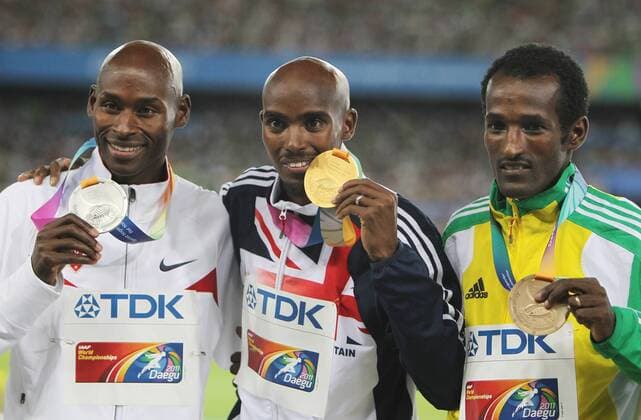 DAEGU, Sept. 4, 2011 -- Gold medalist Mohamed Mo Farah of Britain (C) reacts on the podium between silver medalist Bernard Lagat of the USA and bronze medalist Dejen Gebremeskel of Ethiopia (R) during the awarding ceremony for the men s 5,000 metres event at the IAAF World Athletics Championships in Daegu, September 4, 2011. 