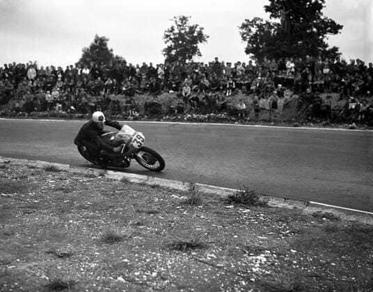 Geoff Duke , British world road racing motorcycle champion , racing at Brands Hatch circuit in Kent . 24th September 1955 UnitedArchives1246707
