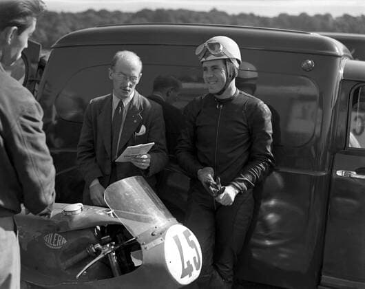 Geoff Duke , British world road racing motorcycle champion , relaxes during practise at the Brands Hatch racing curcuit in Kent . 24th September 1955 UnitedArchives1246724