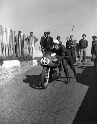 Geoff Duke , British world road racing motorcycle champion , setting off for another practise lap at the Brands Hatch racing circuit in Kent . 24th September 1955 UnitedArchives1246726