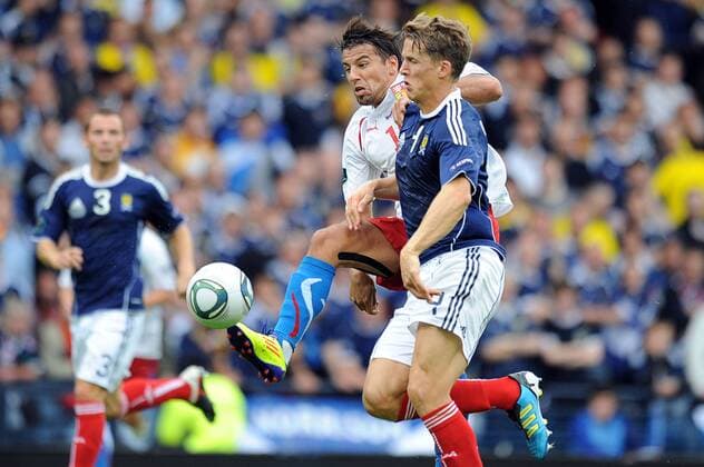 Football - Euro 2012 Qualifier - Scotland vs. Czech Republic Milan Baros (Czech Republic) and Christophe Berra (Scotland) battle for the ball at Hampden Park 