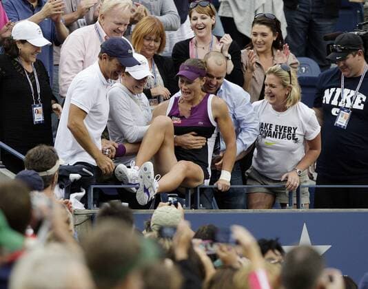 Samantha Stosur of Australia jumps in the seats where her family in the Women s Final in Arthur Ashe Stadium at the U.S. Open Tennis Championships at the Billie Jean King National Tennis Center in New York City on September 11, 2011.  NYP20110911140