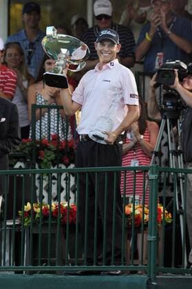 Bill Haas of Greenville, S.C., holds up the FedExCup trophy after winning the Tour Championship golf tournament in a three-hole playoff against Hunter Mahan at the East Lake Golf Club in Atlanta, Georgia, on Sunday, September 25, 2011.  ATL20110925335 Fed Ex