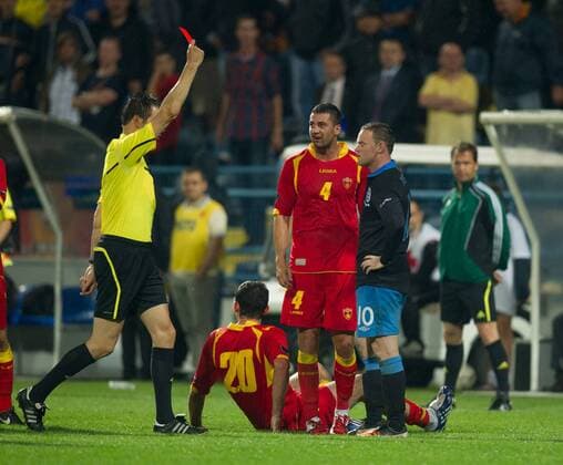 Wayne Rooney of England is shown the red card by referee Wolfgang Stark as Miodrag Dzudovic of Montenegro sits on the ground following his tackle European Championship Qualifying Group G Montenegro v England 7th October, 2011 EDITORIAL USE ONLY. No use with unauthorised audio, video, data, fixture lists, club league logos or live services. Online in-match use limited to 120 images, no video emulation. No use in betting, games or single club league player publications. o0 rote Karte o00 Euro
