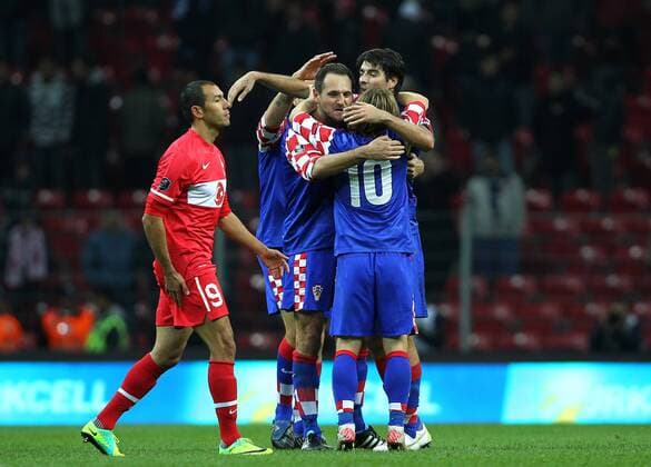 UEFA Euro 2011 play off first leg match between Turkey and Croatia ( blue) at Turk Telekom Arena Stadium in Istanbul, Turkey 11.11.2011 Match scored: Turkey 0 - Croatia 3 Pictured: Croatia s footballer Josip Simunic and Vedran Corluka celebrate with team mates after the won. Umut Bulut looks dejected.  o0 Jubel Freud und Leid