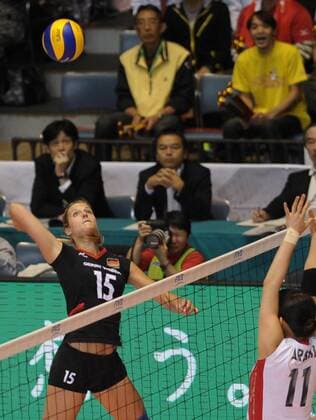 Maren Brinker (L) of Germany spikes the ball during the match against Japan at the FIVB Women s World Cup 2011 in Tokyo, Japan, on Nov. 17, 2011. Japan won 3-2 - 