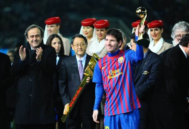 Lionel Messi (Front) holds the Adidas Gold Ball trophy during the awarding ceremony after the final match at the Club World Cup in Yokohama - FC Barcelona won 4-0 and claimed the title - 