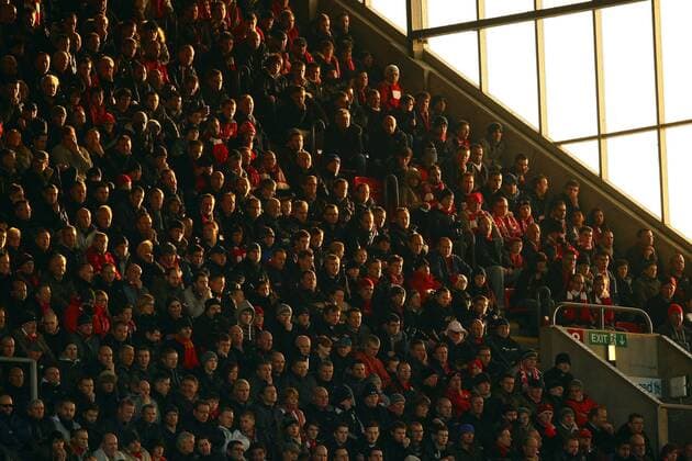 Football - Premier League - Liverpool FC fans bask in the sunlight in the Centenary stand at Anfield 