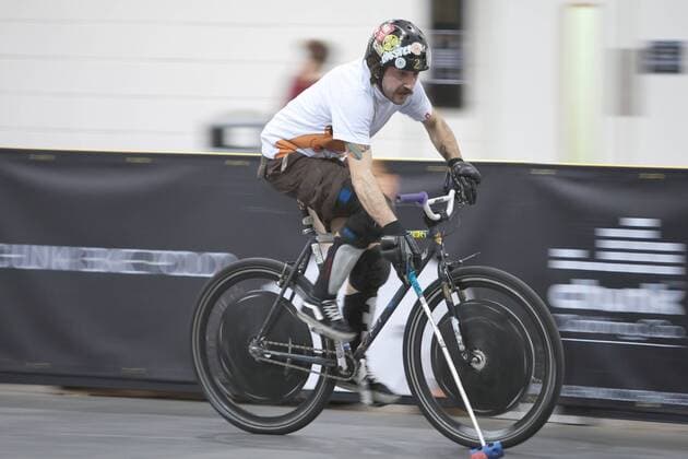 15.01.12 London, England. Player chases with the ball during the London International Invitational bike polo finals match at The Bike Show between L Equipe (blue shirts) from Geneva, Switzerland and Tigers (white shirts) from Venezia, Italy at ExCeL Centre, East London. xDavidxFearn ActionxPlusx  ActionPlus11235026